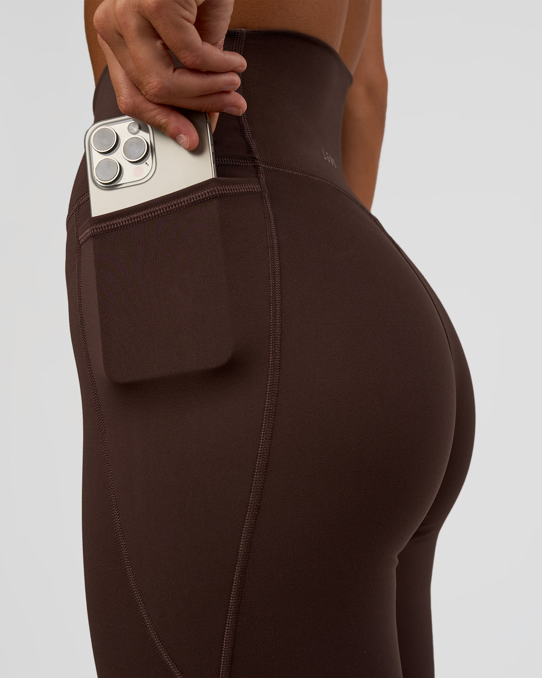Woman wearing Fusion V-Contour Ultra High-Rise Full Length Legging Pockets - Hot Chocolate | Model:Amity | Size:S - view 3
