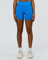 Woman wearing Fusion V-Contour Ultra High-Rise 6" Short Pockets - Palace Blue | Model:Rosie | Size:S | Thumbnail Index: 1