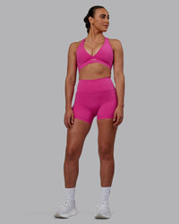 Woman wearing Fusion Ultra High-Rise 4" Short Pockets - Fuchsia Pink | Model:Sophie | Size:S | Thumbnail Index: 1