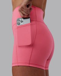 Woman wearing Fusion Ultra High-Rise 4" Short Pockets - Pink Lemonade | Model:Shae | Size:S | Thumbnail Index: 1
