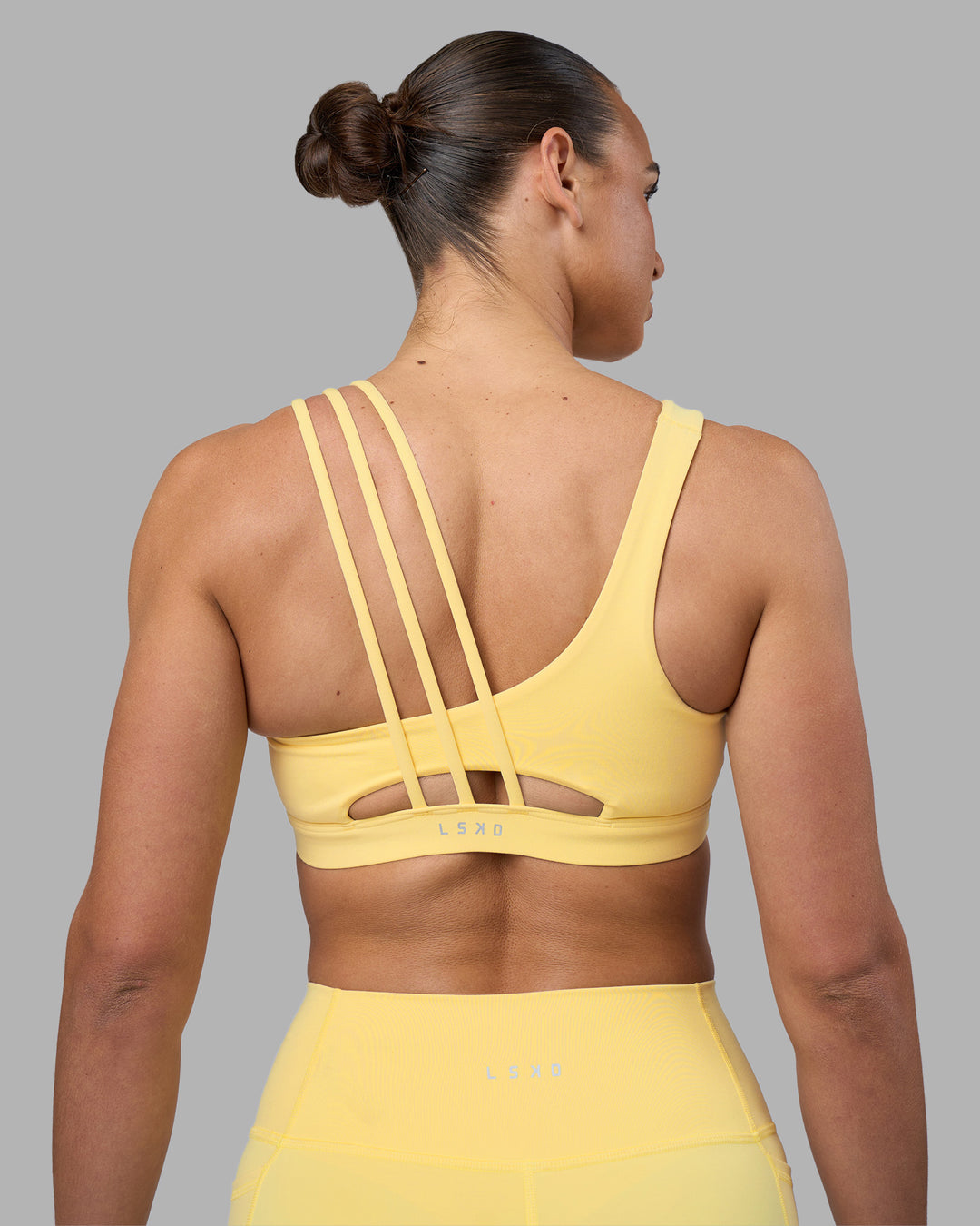Woman wearing Galvanise Sports Bra 2.0 - Lemon | Set:true | Angle:back | Model:Sophie | Size:S - view 2