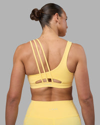 Woman wearing Galvanise Sports Bra 2.0 - Lemon | Set:true | Angle:back | Model:Sophie | Size:S | Thumbnail Index: 1