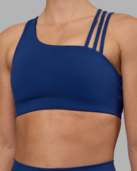 Woman wearing Galvanise Sports Bra 2.0 - Midnight Blue | Set:true | Angle:closeup | Model:Charlize | Size:S | Thumbnail Index: 6
