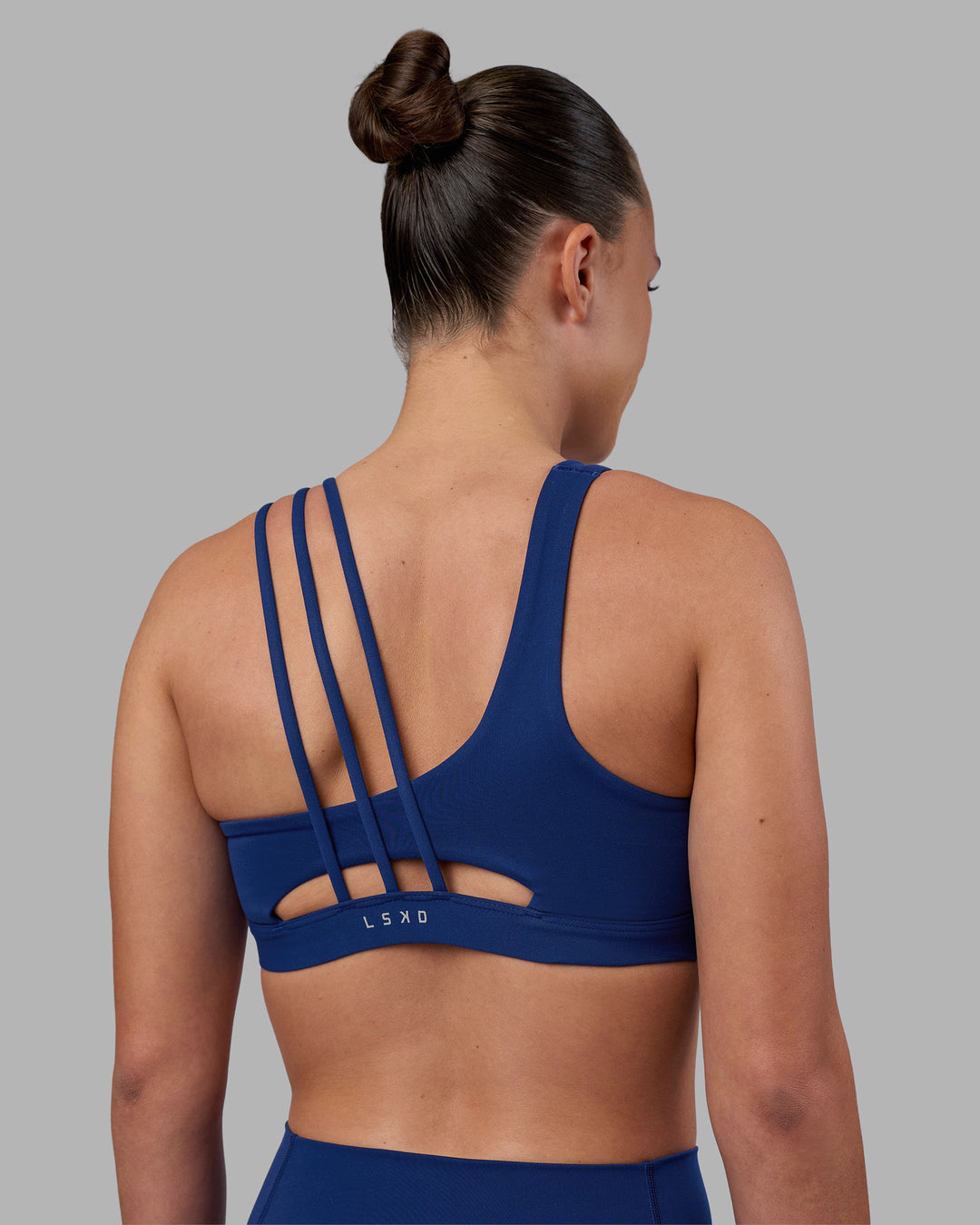 Woman wearing Galvanise Sports Bra 2.0 - Midnight Blue | Set:true | Angle:back | Model:Charlize | Size:S - view 2
