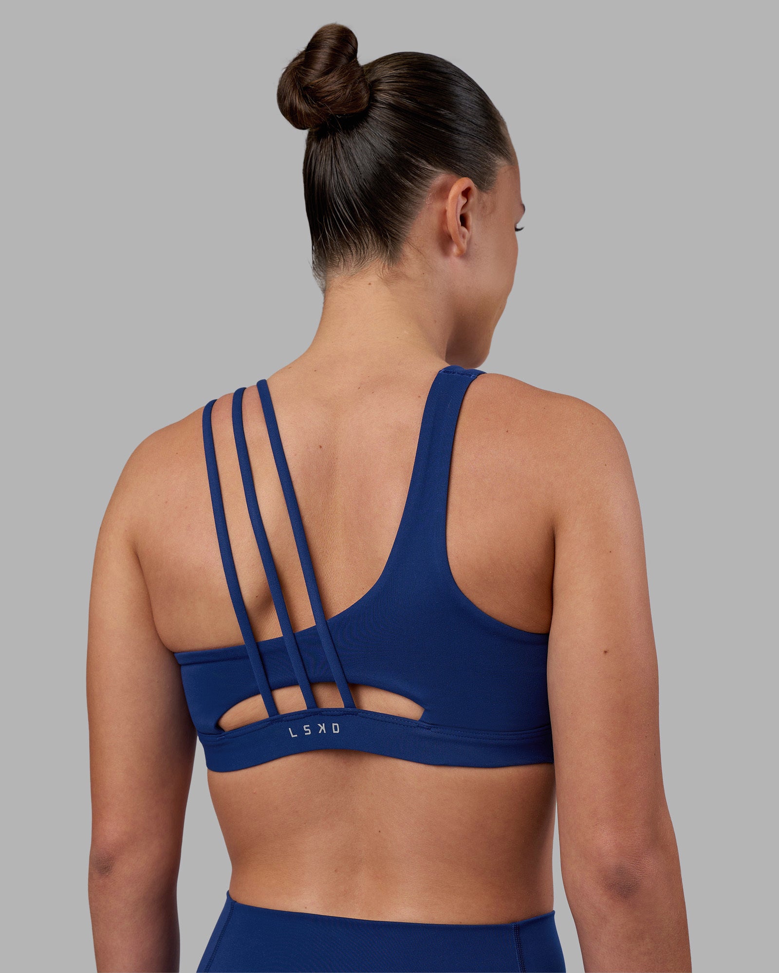 Woman wearing Galvanise Sports Bra 2.0 - Midnight Blue | Set:true | Angle:back | Model:Charlize | Size:S