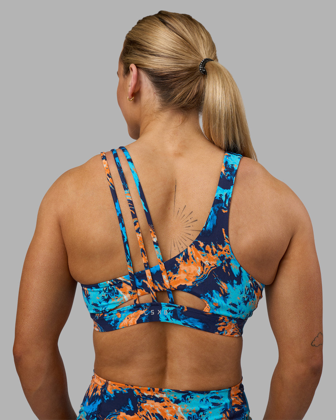 Woman wearing Galvanise Sports Bra 2.0 - React Print | Set:true | Angle:back | Model:Georgia | Size:S - view 1