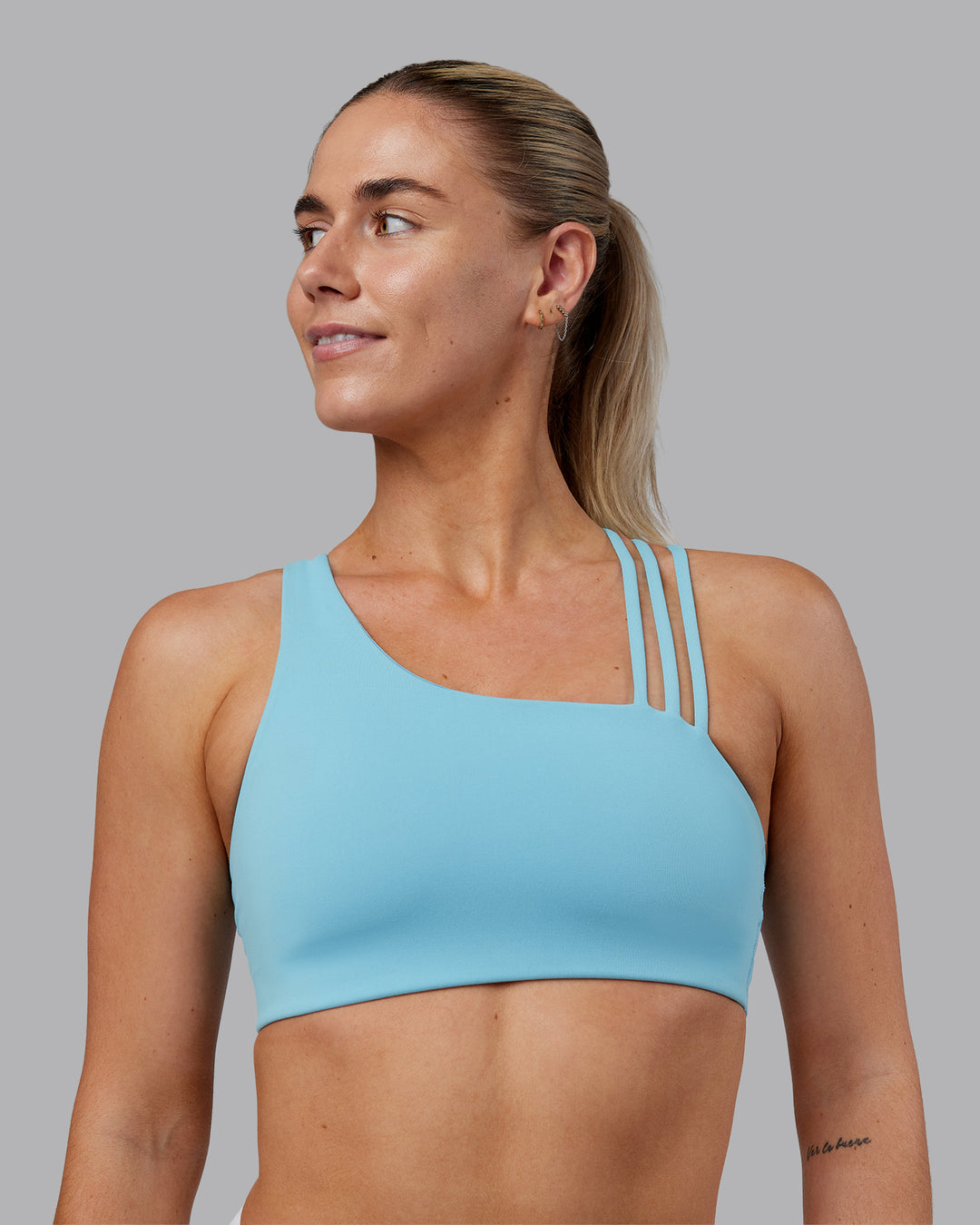 Woman wearing Galvanise Sports Bra 2.0 - Retro Blue | Set:true | Angle:front | Model:Hannah | Size:S - view 1