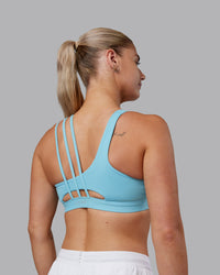 Woman wearing Galvanise Sports Bra 2.0 - Retro Blue | Set:true | Angle:back | Model:Hannah | Size:S | Thumbnail Index: 1