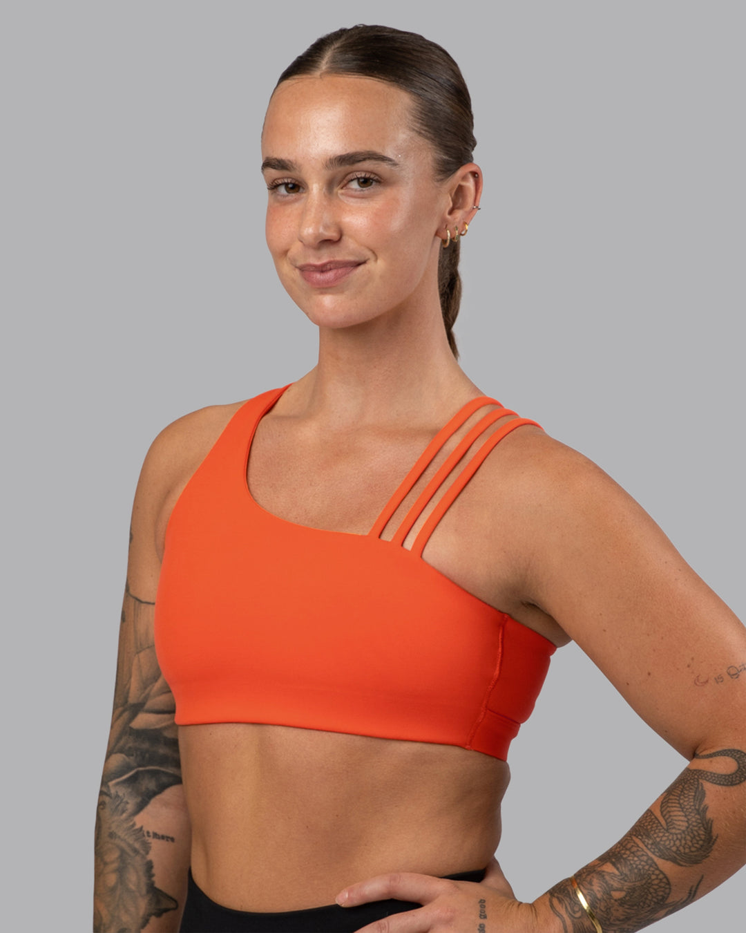 Woman wearing Galvanise Sports Bra 2.0 - Ultra Orange | Set:true | Angle:front | Model:Robyn | Size:S - view 1