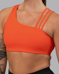 Woman wearing Galvanise Sports Bra 2.0 - Ultra Orange | Set:true | Angle:closeup | Model:Robyn | Size:S | Thumbnail Index: 3