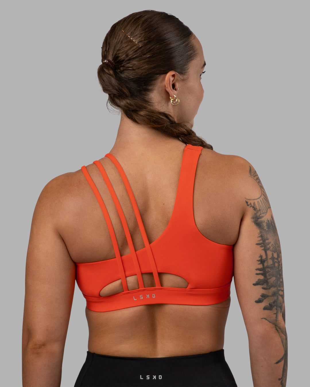 Woman wearing Galvanise Sports Bra 2.0 - Ultra Orange | Set:true | Angle:back | Model:Robyn | Size:S - view 2