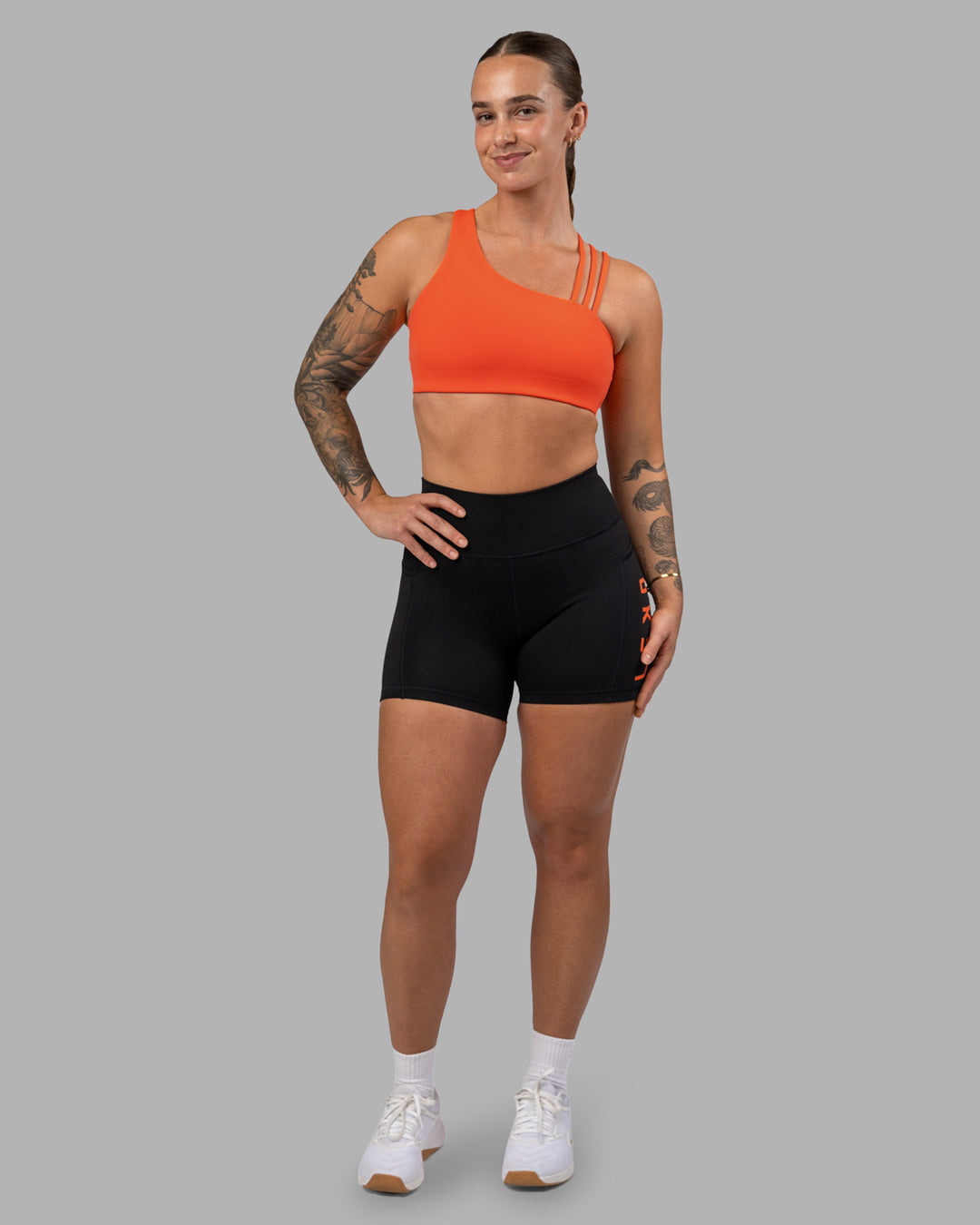 Woman wearing Galvanise Sports Bra 2.0 - Ultra Orange | Model:Robyn | Size:S - view 3