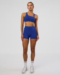Woman wearing Galvanise Sports Bra 2.0 - Electric Indigo | Model:Evie | Size:S | Thumbnail Index: 2