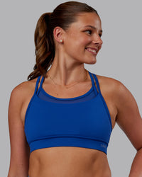 Woman wearing Genesis Layered Sports Bra - Blue Quartz | Model:Phoebe | Size:S | Thumbnail Index: 0