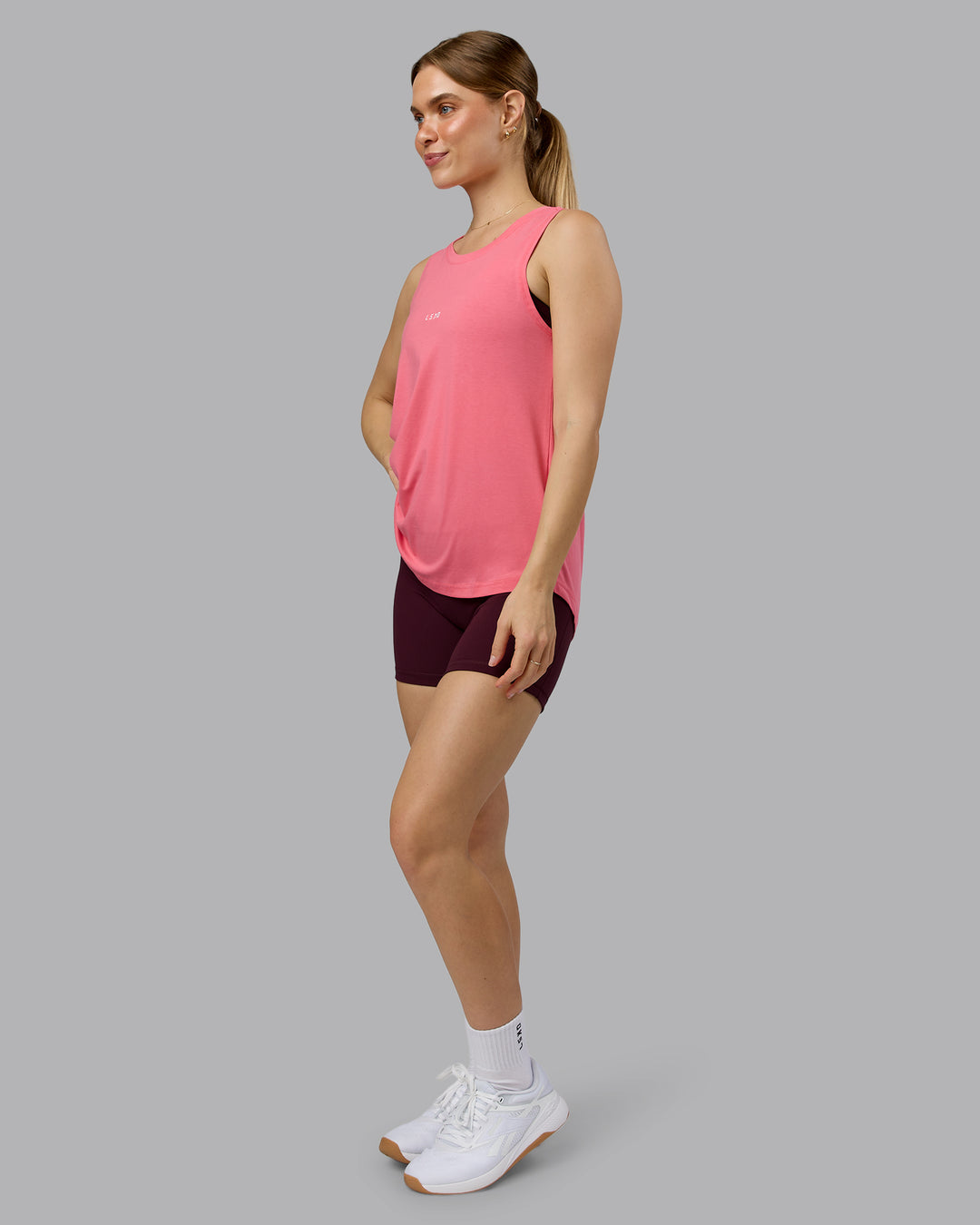 Woman wearing Go-To FLXCotton Longline Tank - Pink Lemonade-White | Model:Emilie | Size:S - view 2