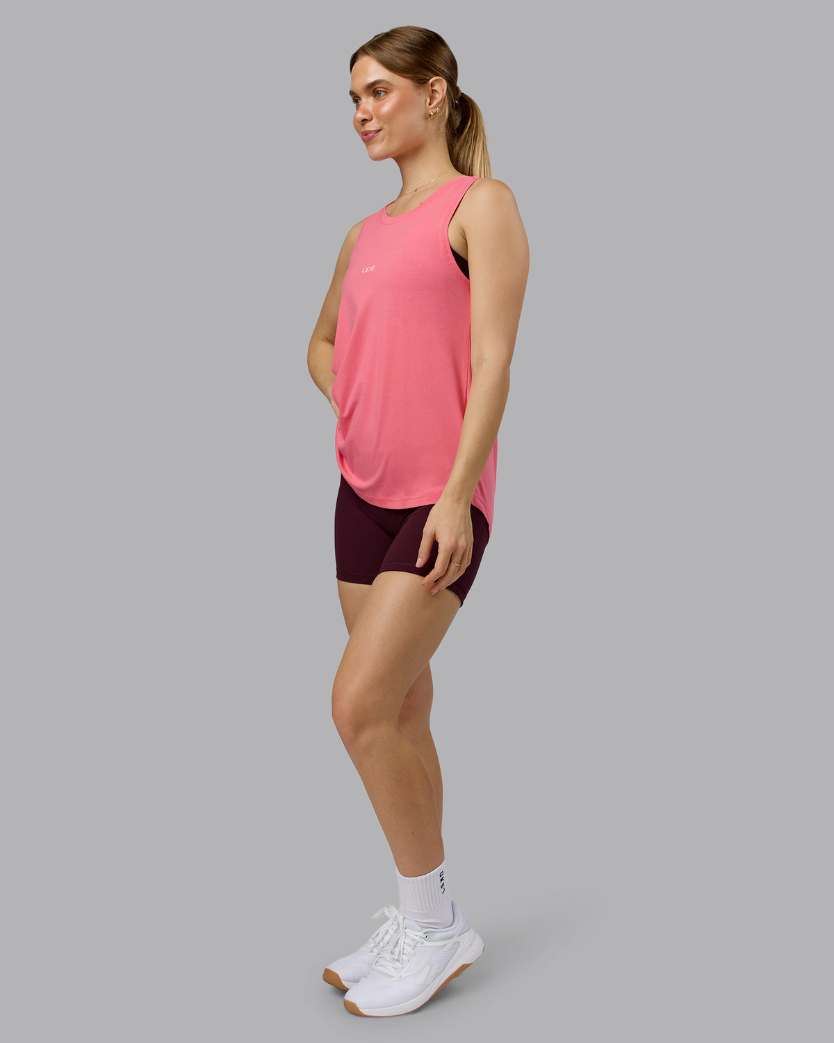 Woman wearing Go-To FLXCotton Longline Tank - Pink Lemonade-White | Model:Emilie | Size:S