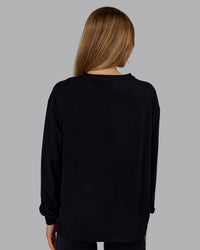 Woman wearing Go-To Long Sleeve FLXCotton Oversized Tee - Black-White | Model:Emilie | Size:S | Thumbnail Index: 2