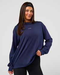 Woman wearing Go-To Long Sleeve FLXCotton Oversized Tee - Future Navy-White | Model:Bianca | Size:S | Thumbnail Index: 0