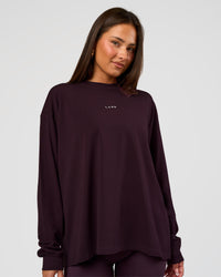 Woman wearing Go-To Long Sleeve FLXCotton Oversized Tee - Midnight Plum-White | Model:Bianca | Size:S | Thumbnail Index: 0