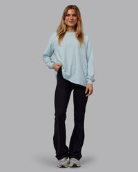 Woman wearing Go-To Long Sleeve FLXCotton Oversized Tee - Skyride-White | Model:Emilie | Size:S | Thumbnail Index: 0
