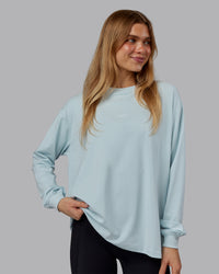 Woman wearing Go-To Long Sleeve FLXCotton Oversized Tee - Skyride-White | Model:Emilie | Size:S | Thumbnail Index: 1