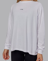 Woman wearing Go-To Long Sleeve FLXCotton Oversized Tee - White-Black | Model:Emilie | Size:S | Thumbnail Index: 3