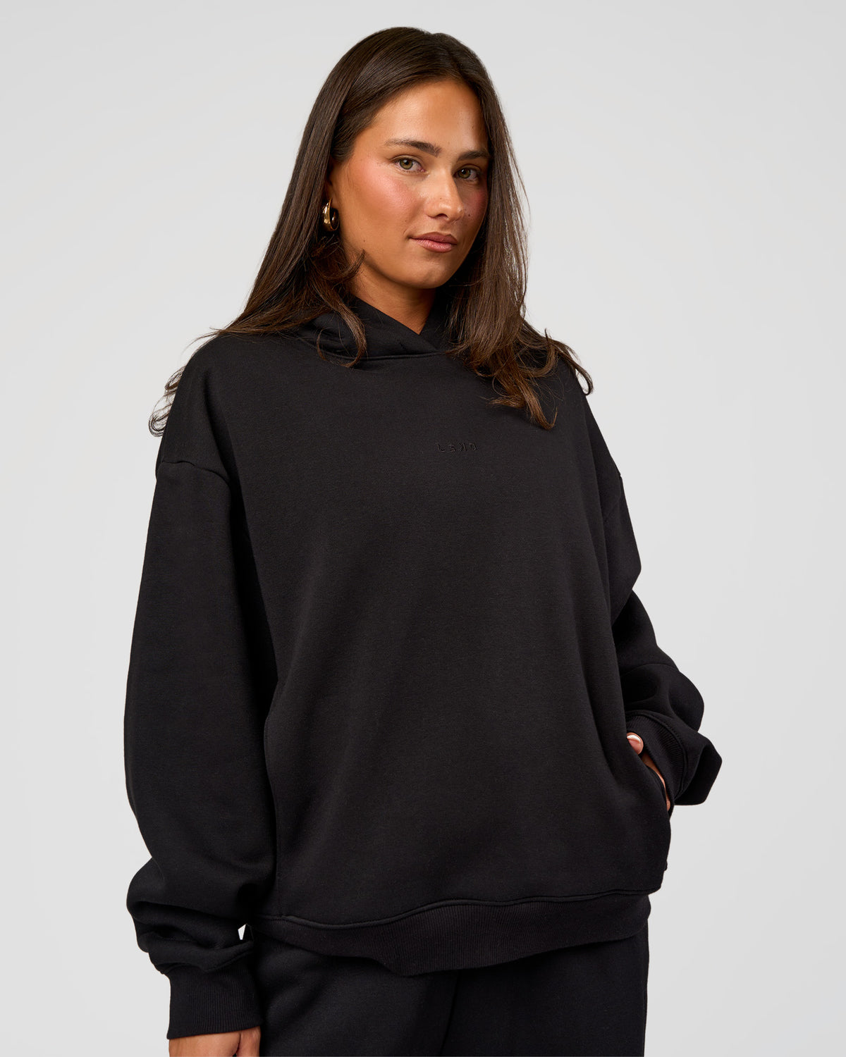 Woman wearing Go-To Oversized Hoodie - Black | Model:Bianca | Size:S