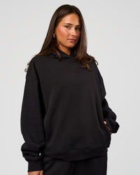 Woman wearing Go-To Oversized Hoodie - Black | Model:Bianca | Size:S | Thumbnail Index: 0