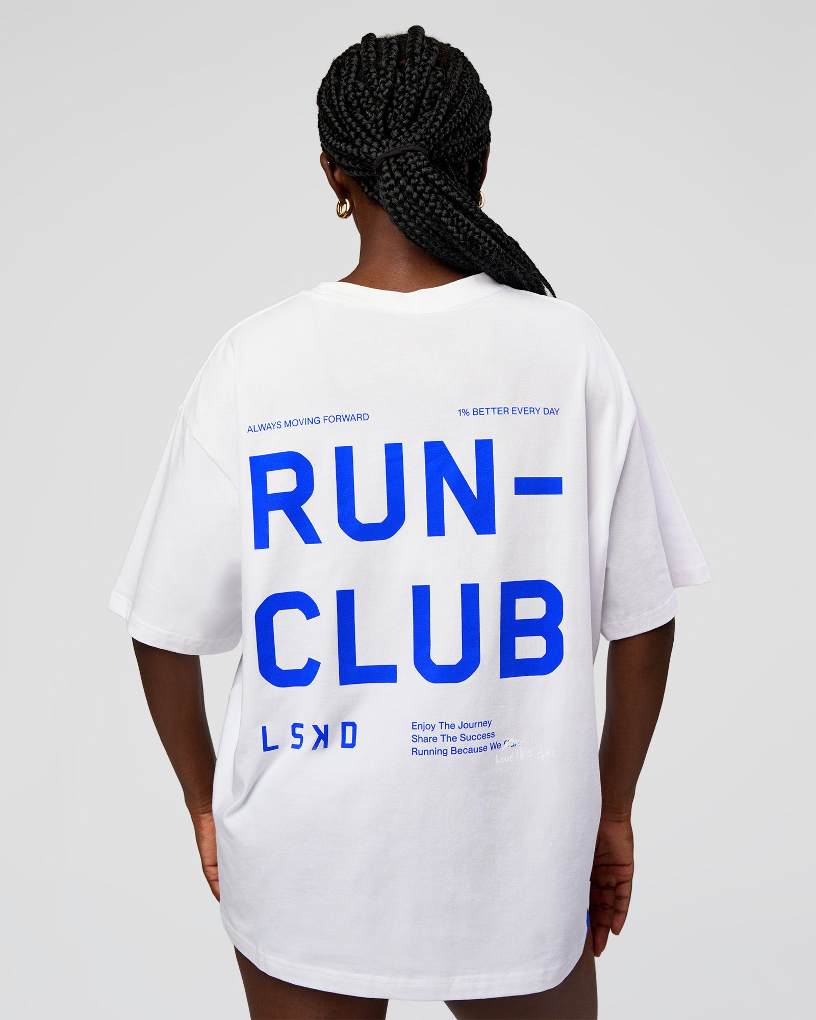 Woman wearing Go-To Run Club FLXCotton Oversized Tee - White-Electric Indigo | Model:Ellie | Size:S