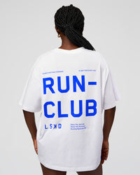 Woman wearing Go-To Run Club FLXCotton Oversized Tee - White-Electric Indigo | Model:Ellie | Size:S | Thumbnail Index: 0