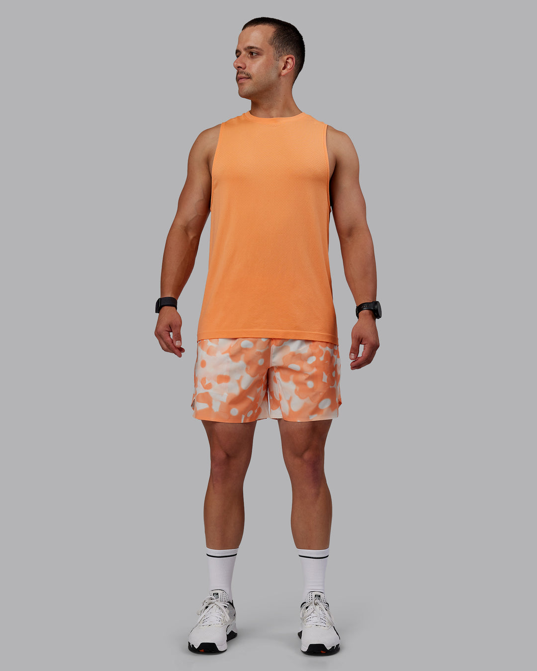 Man wearing Grand Slam 6" Shorts in Wildflower Cantaloupe | Size:S - view 9