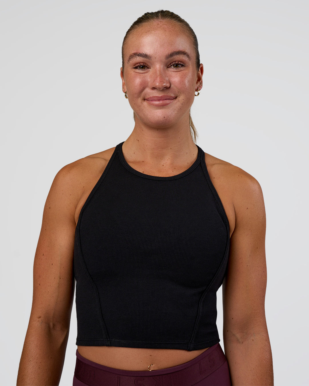Woman wearing Ignite High Neck Tank - Black | Model:Sav | Size:S - view 1