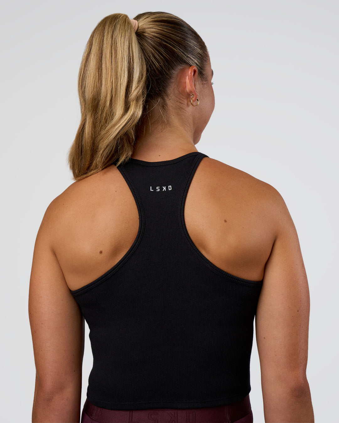 Woman wearing Ignite High Neck Tank - Black | Model:Sav | Size:S - view 3