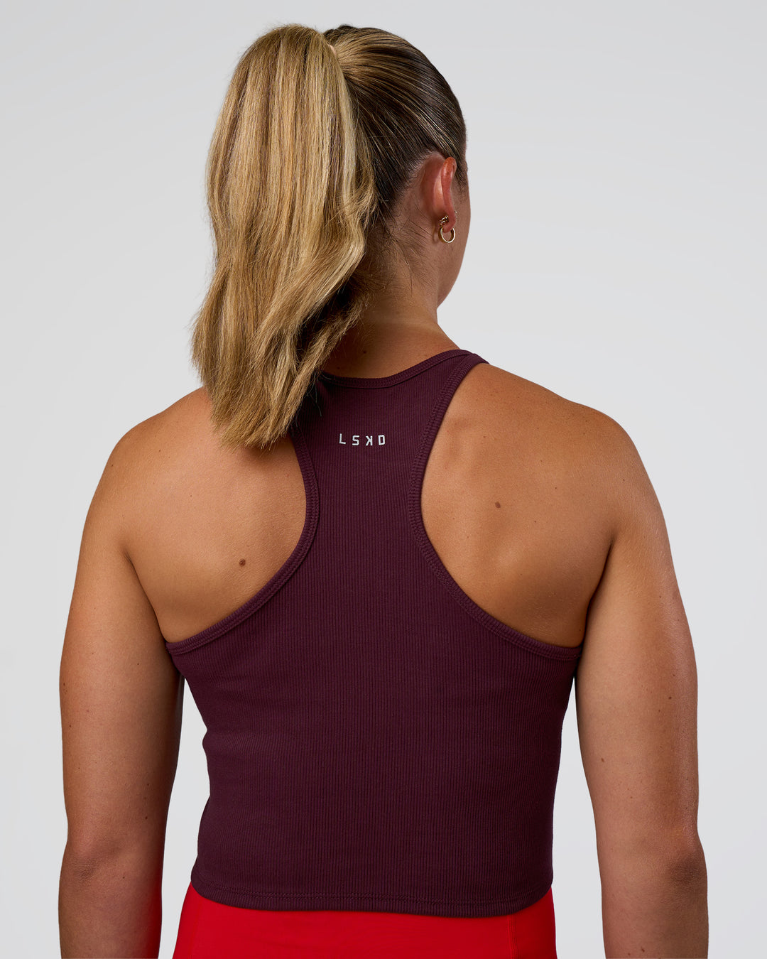 Woman wearing Ignite High Neck Tank - Cherry Lacquer | Model:Sav | Size:S - view 2