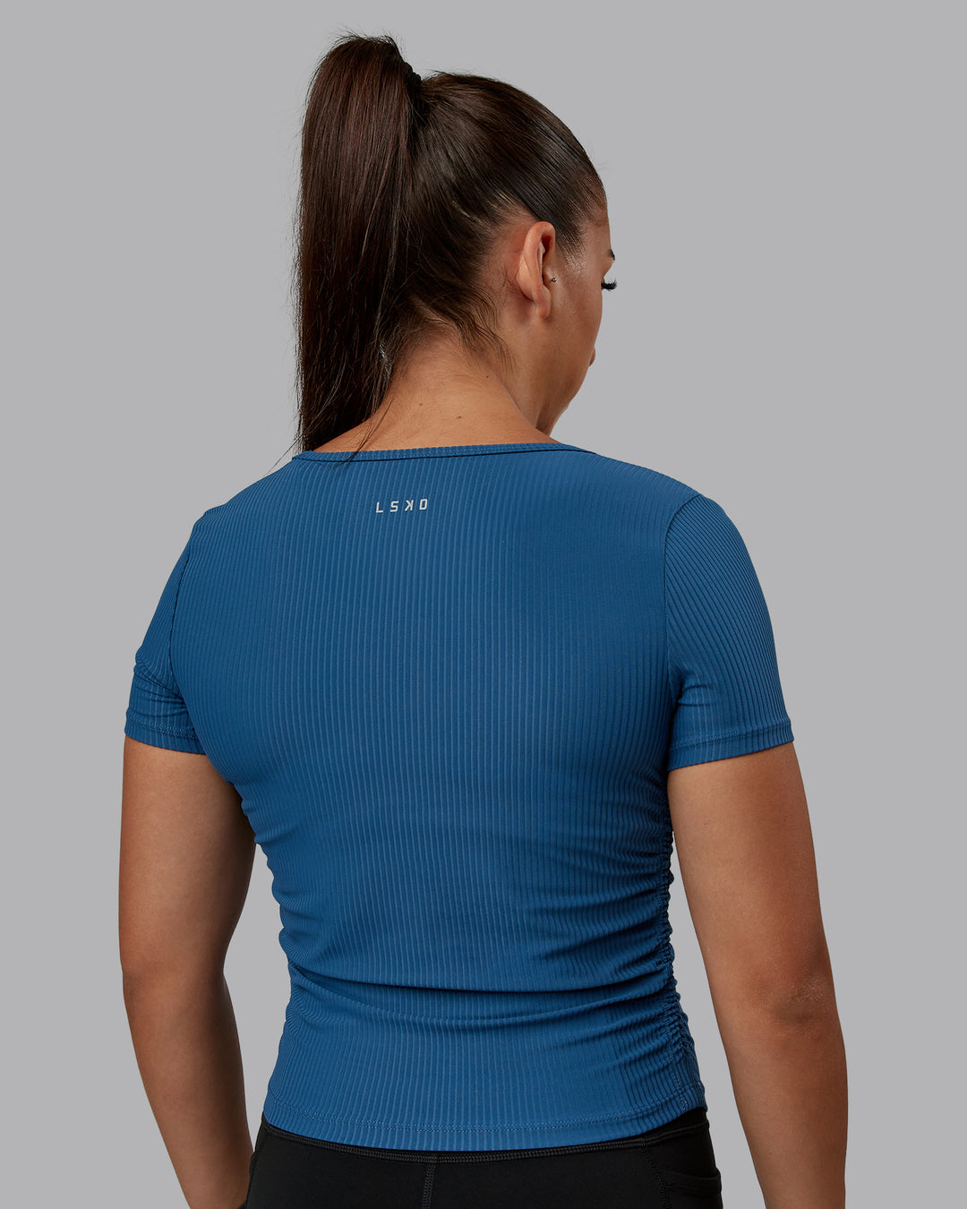 Woman wearing Ignite Ribbed Scrunch Side Cropped Tee - Indigo | Size:S | Model:Tylah - view 3
