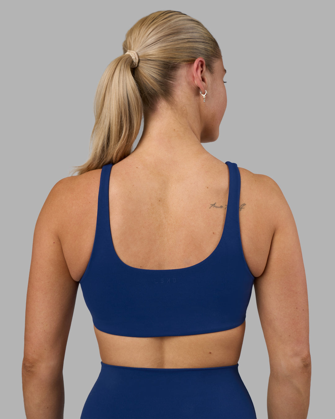 Woman wearing Impulse Reversible Sports Bra - Midnight Blue | Model:Hannah | Size:S - view 4