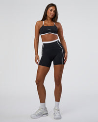 Woman wearing Liberate Contrast High-Rise 6" Short Pockets - Black-White | Model:Bianca | Size:S | Thumbnail Index: 1