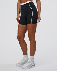 Woman wearing Liberate Contrast High-Rise 6" Short Pockets - Black-White | Model:Bianca | Size:S | Thumbnail Index: 0