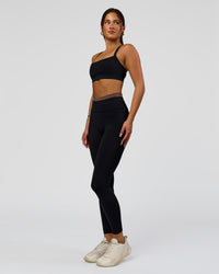 Woman wearing Liberate High-Rise Full Length Legging Pockets in Black-Cocoa Powder | Model:Bianca | Size:S | Thumbnail Index: 5