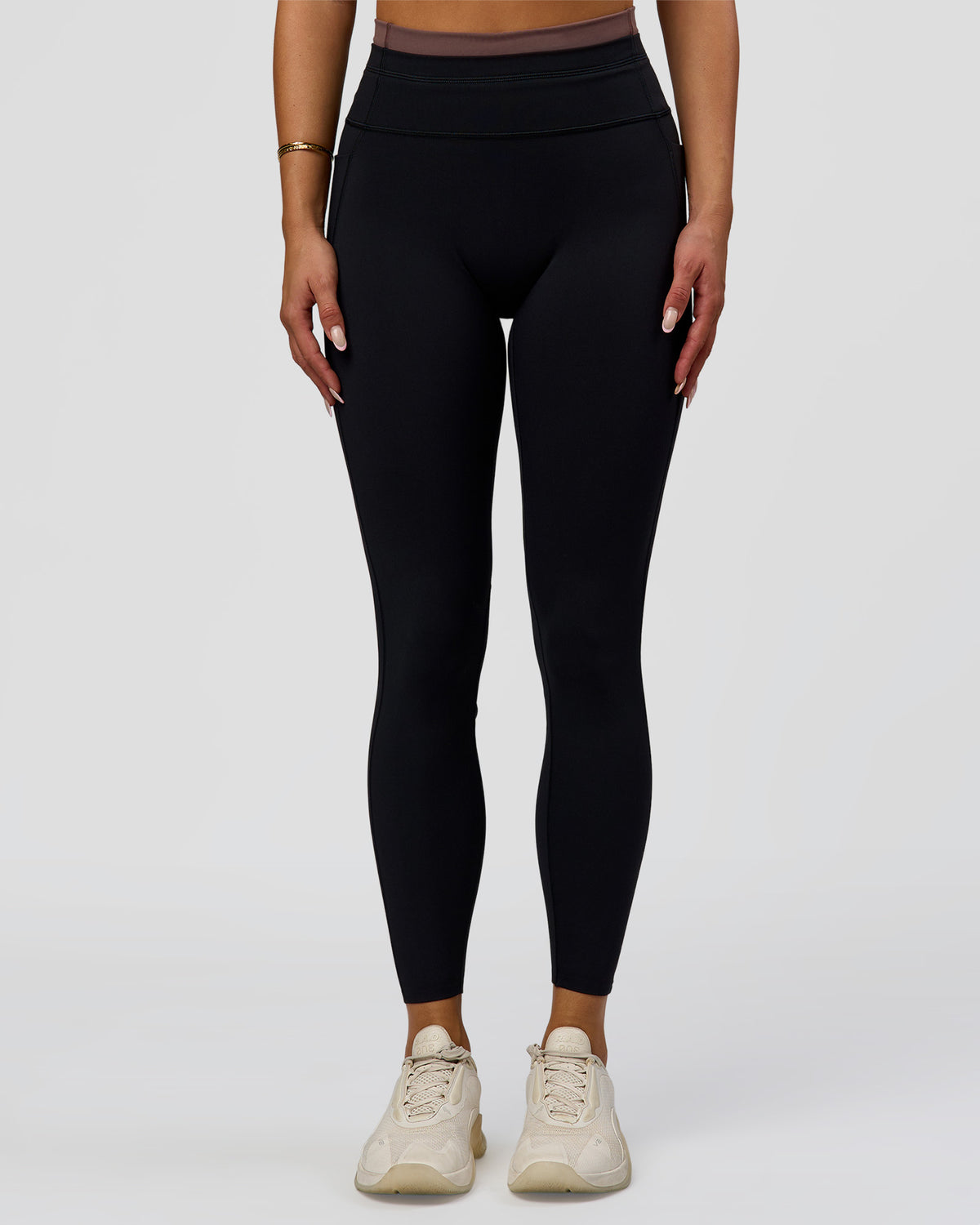Woman wearing Liberate High-Rise Full Length Legging Pockets in Black-Cocoa Powder | Model:Bianca | Size:S