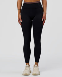 Woman wearing Liberate High-Rise Full Length Legging Pockets in Black-Cocoa Powder | Model:Bianca | Size:S | Thumbnail Index: 0