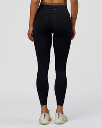 Woman wearing Liberate High-Rise Full Length Legging Pockets in Black-Cocoa Powder | Model:Bianca | Size:S | Thumbnail Index: 8