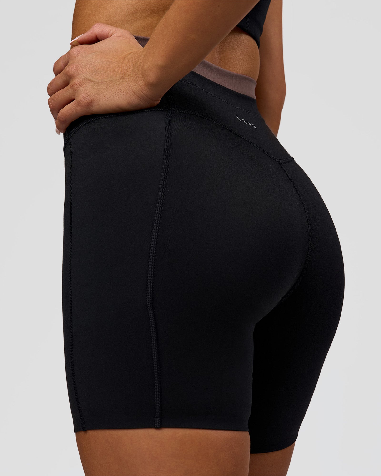 Woman wearing Liberate High-Rise 6" Short Pockets in Black-Cocoa Powder | Model:Bianca | Size:S