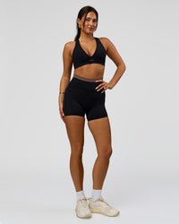 Woman wearing Liberate High-Rise 4" Short Pockets in Black-Cocoa Powder | Model:Bianca | Size:S | Thumbnail Index: 2