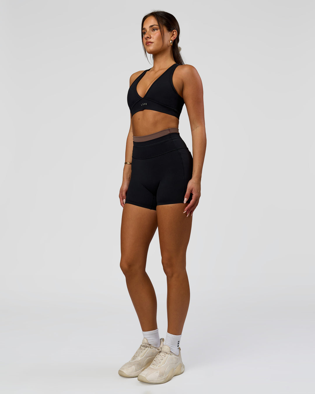 Woman wearing Liberate High-Rise 4" Short Pockets in Black-Cocoa Powder | Model:Bianca | Size:S - view 5