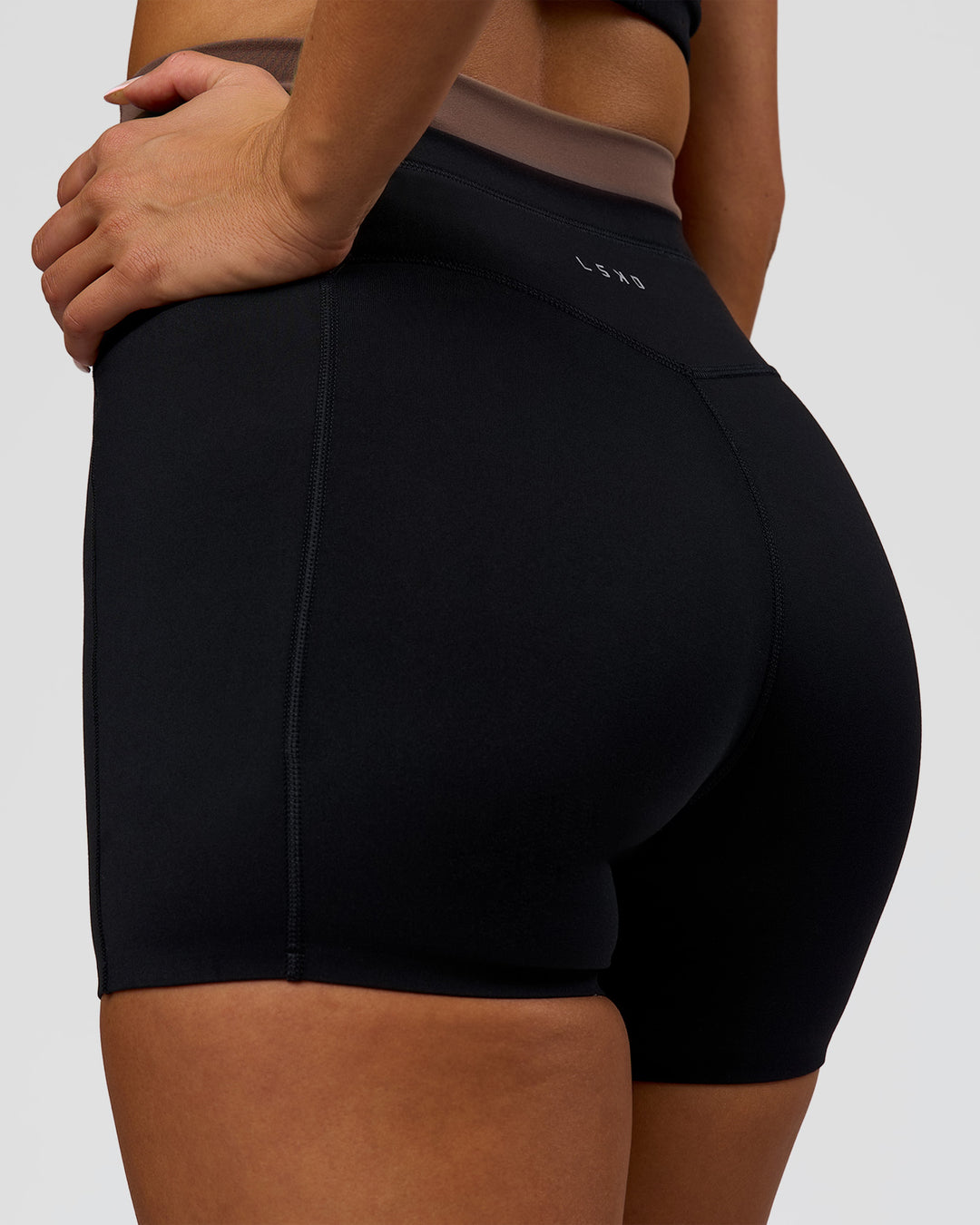Woman wearing Liberate High-Rise 4" Short Pockets in Black-Cocoa Powder | Model:Bianca | Size:S - view 9
