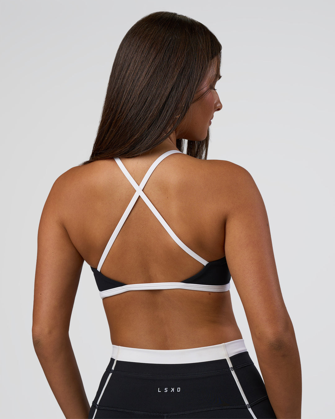 Woman wearing Liberate Sports Bra - Black-White | Model:Bianca | Size:S - view 4