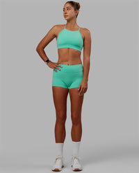 Woman wearing Lift High Neck Sports Bra - Cockatoo | Thumbnail Index: 6