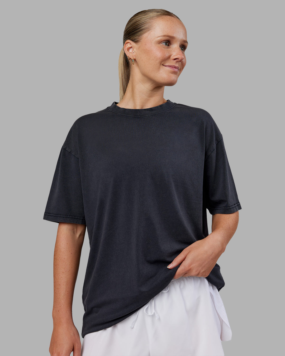 Woman wearing Love The Run FLXCotton Tee Oversize - Black Washed-Circular Grey | Model:Neve | Size:S - view 3