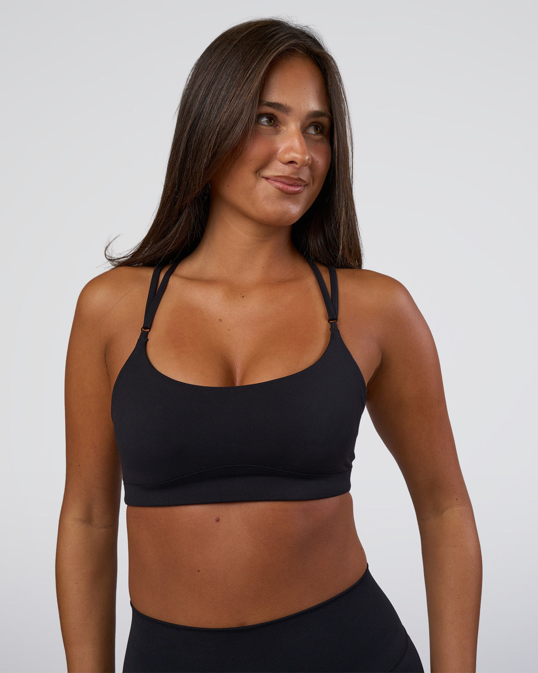 Woman wearing Luminate Sports Bra - Black | Model:Bianaca | Size:S - view 2